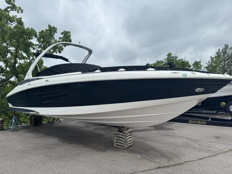 Slide: The Image of Azure AZ298 boat from 2012 on a trailer, surrounded by trees and cloudy sky. - 22