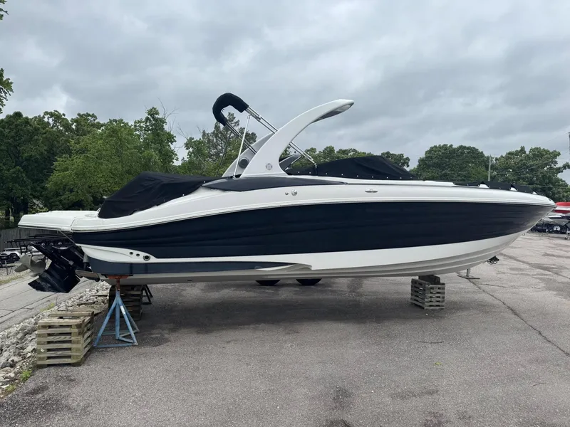 Slide: The Image of 2012 Azure AZ298 boat on stands, black and white design, parked outdoors. - 25