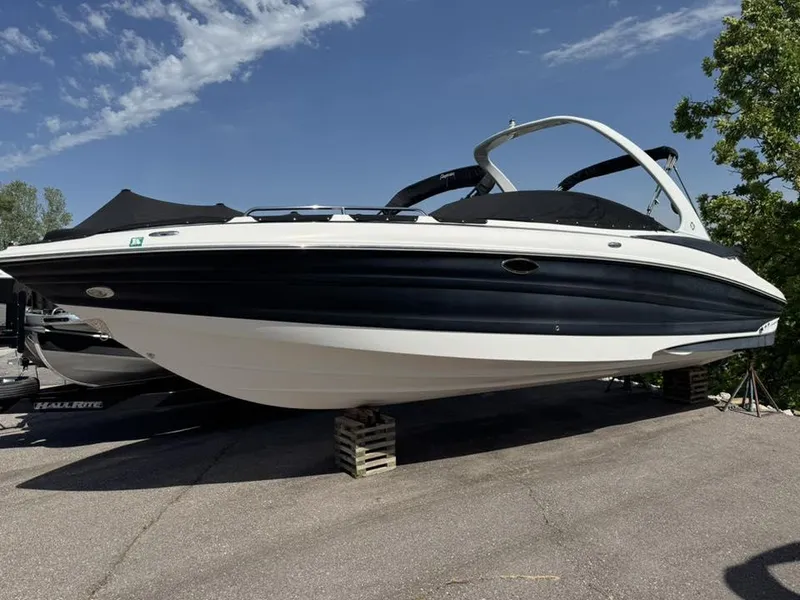 Slide: The Image of Azure AZ298 2012 boat on display, elevated on blocks, under a clear sky. - 28