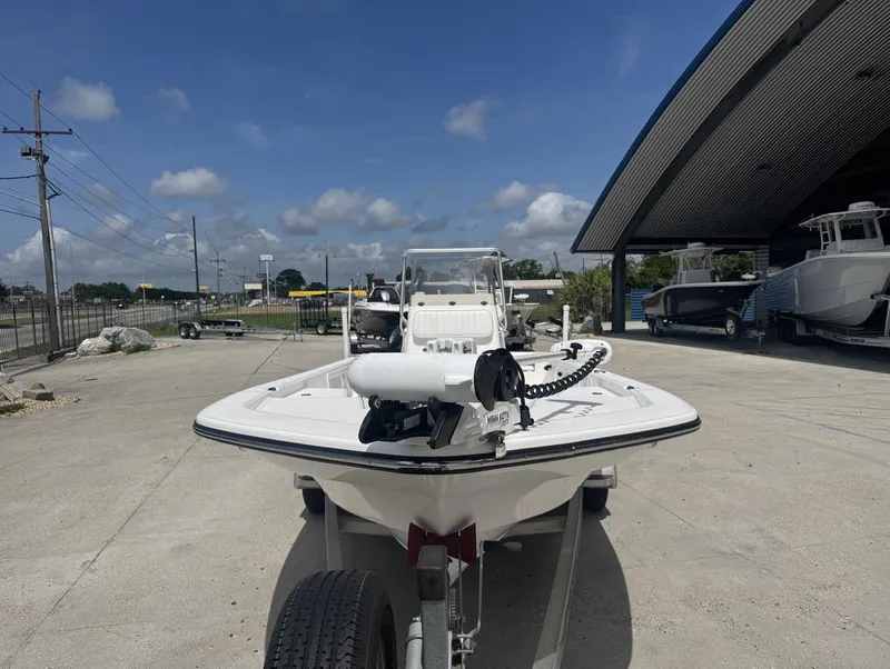 Slide: The Image of 2018 Frontier 2104 boat on trailer, parked outdoors under clear sky. - 10