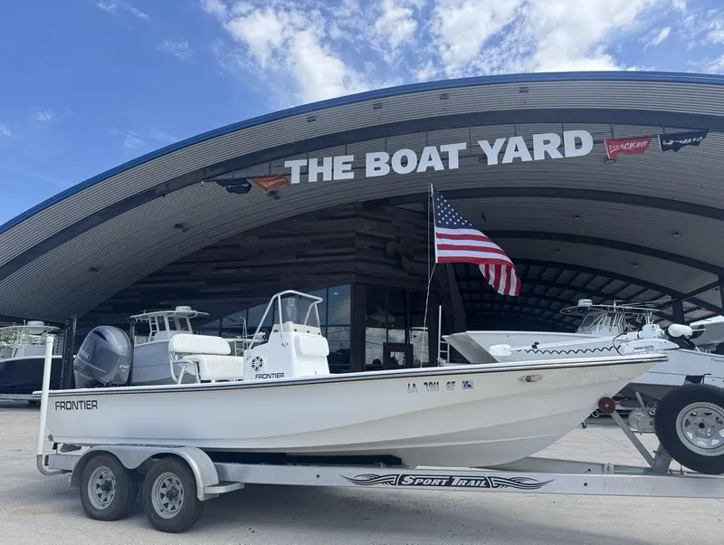 Slide: The Image of 2018 Frontier 2104 boat on trailer at The Boat Yard, American flag displayed. - 11