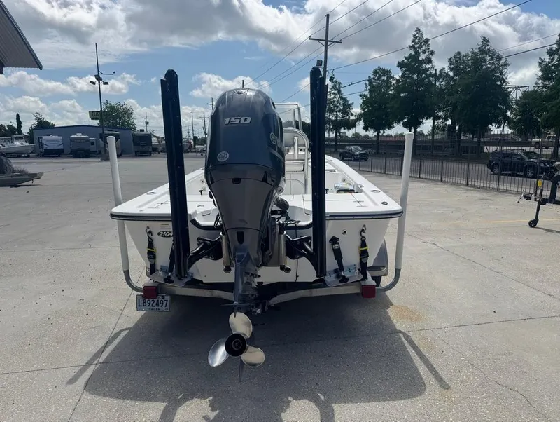 Slide: The Image of 2018 Frontier 2104 boat with outboard motor in a parking lot. - 13