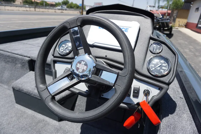 Slide: The Image of 2025 Ranger RT198P boat dashboard with steering wheel and gauges. - 10