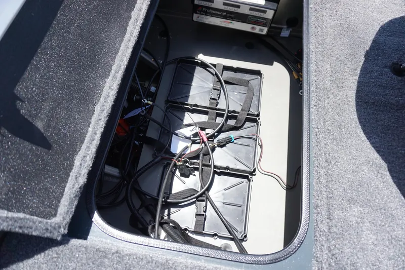 Slide: The Image of Battery compartment of 2025 Ranger RT198P boat with wiring and storage. - 11