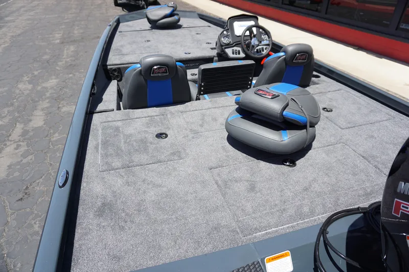 Slide: The Image of 2025 Ranger RT198P boat interior with gray and blue seating, steering console, and spacious deck. - 14