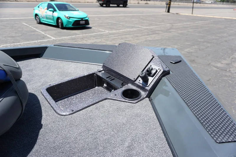 Slide: The Image of 2025 Ranger RT198P boat deck with control panel and cup holder in parking lot. - 15