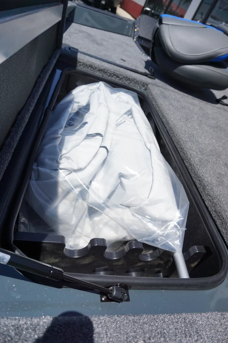Slide: The Image of 2025 Ranger RT198P boat storage compartment with covered equipment. - 17