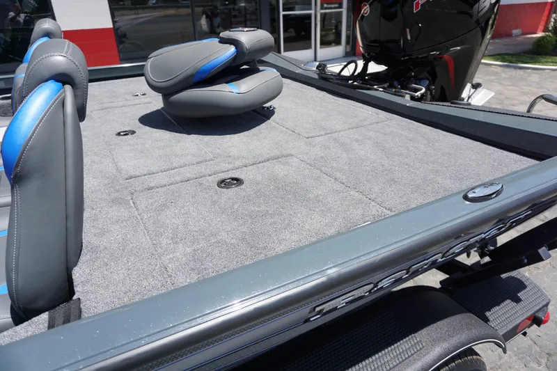 Slide: The Image of 2025 Ranger RT198P boat interior with gray carpet and blue-accented seats. - 5
