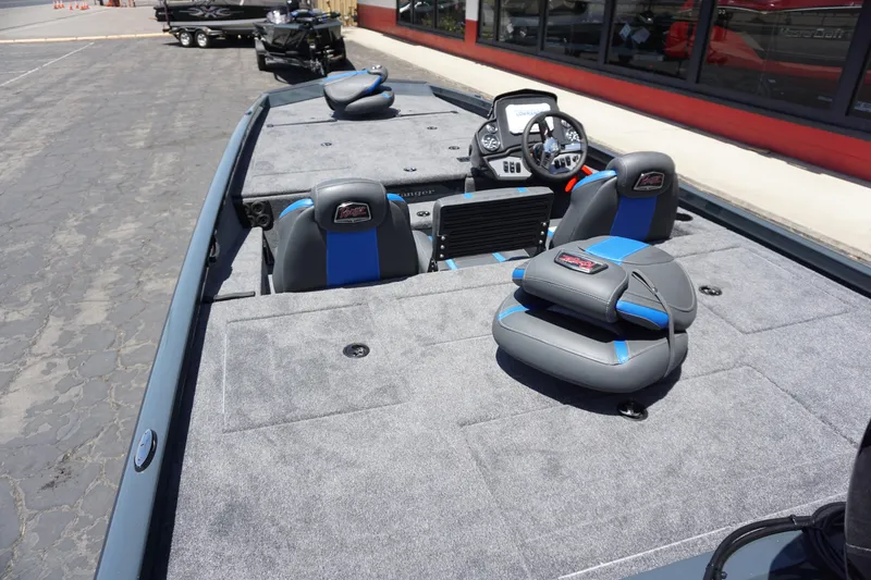 Slide: The Image of 2025 Ranger RT198P boat interior with gray and blue seating, steering console, and spacious deck. - 9