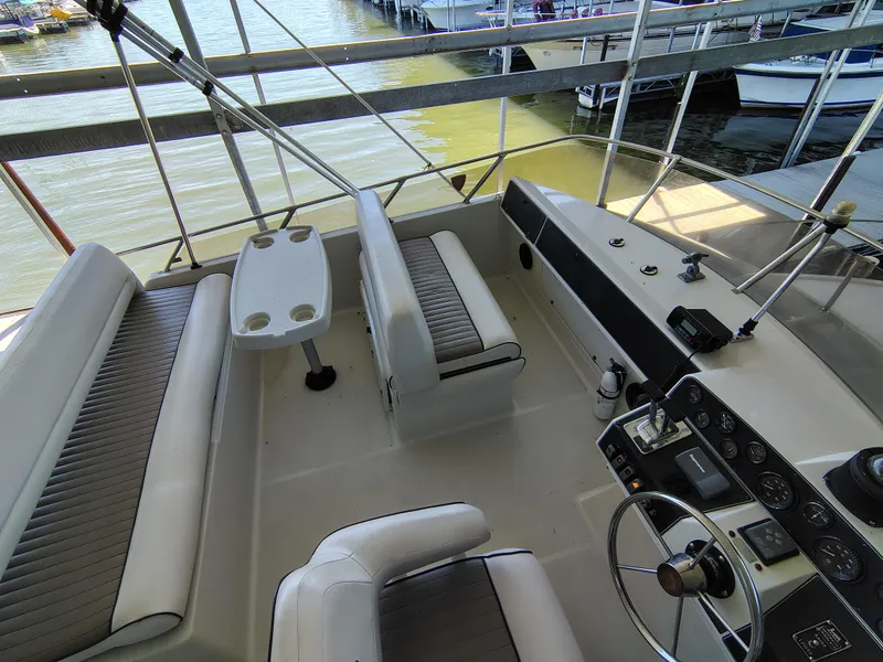 Slide: The Image of 1992 Carver Command Bridge 28 interior with seating and helm, docked at marina. - 1