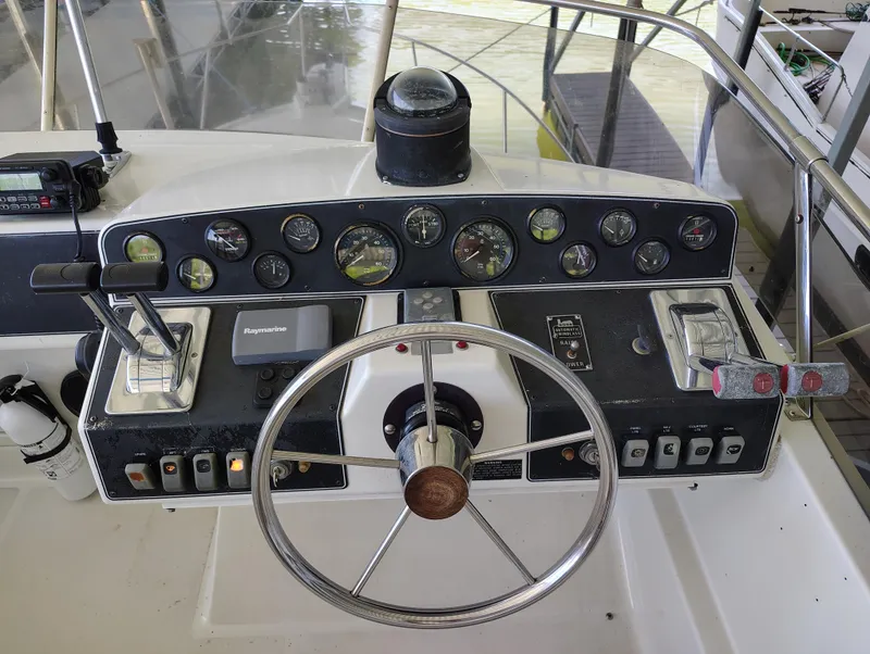 Slide: The Image of 1992 Carver Command Bridge 28 helm with steering wheel, gauges, and controls. - 13