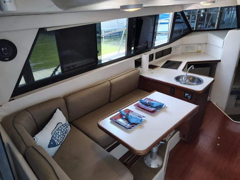 Slide: The Image of Interior of 1992 Carver Command Bridge 28 with dining area and kitchenette. - 17