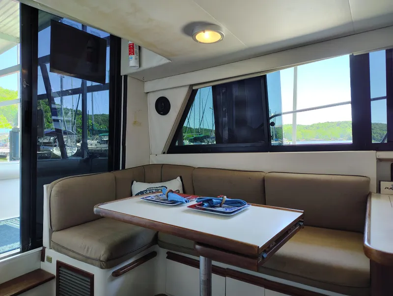 Slide: The Image of Interior of 1992 Carver Command Bridge 28 with cozy seating and dining table. - 18