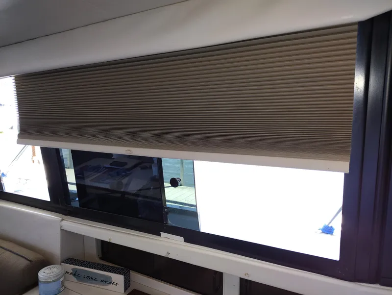 Slide: The Image of Interior view of a 1992 Carver Command Bridge 28 with window blinds partially closed. - 26