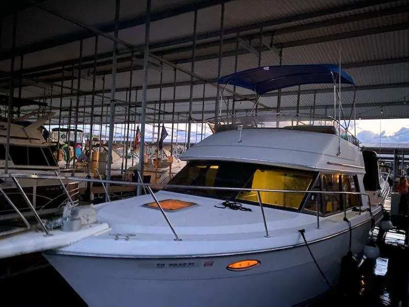 Slide: The Image of 1992 Carver Command Bridge 28 docked in a marina under a covered structure. - 27