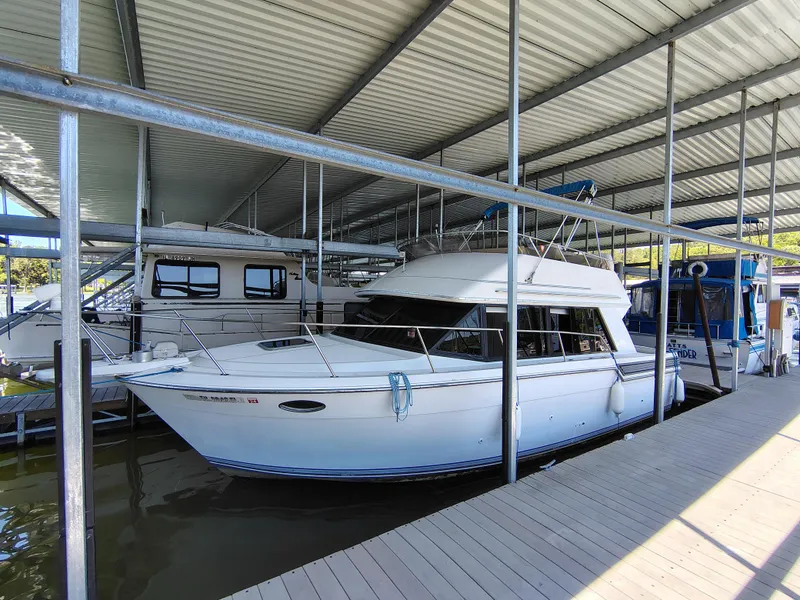 Slide: The Image of 1992 Carver Command Bridge 28 docked under covered marina. - 3