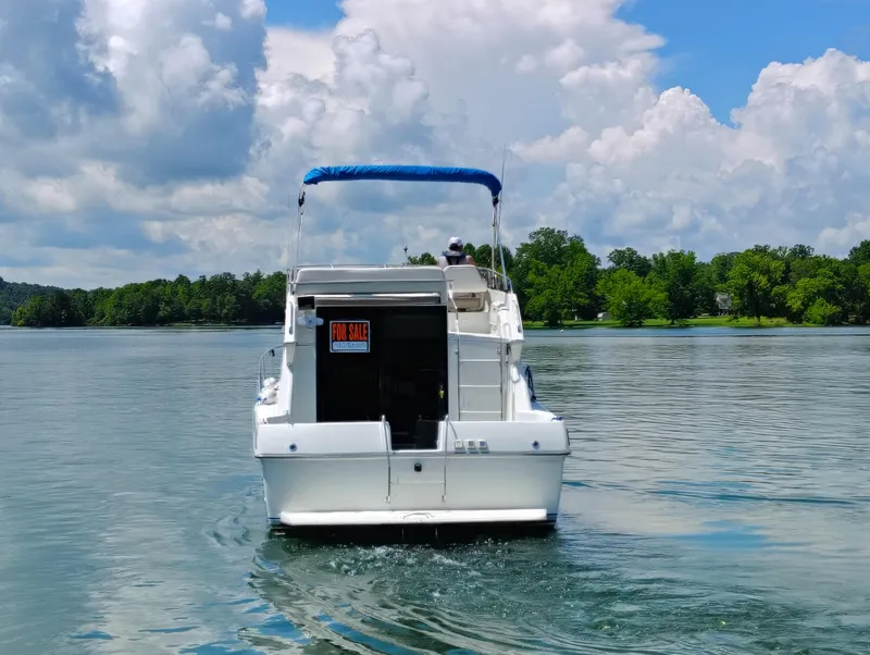 Slide: The Image of 1992 Carver Command Bridge 28 boat for sale on a serene lake. - 34