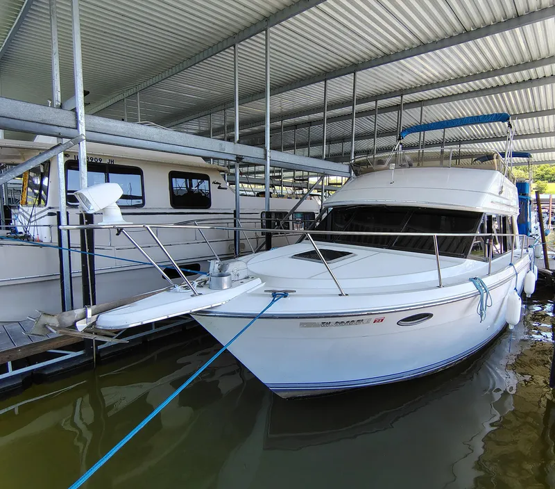 Slide: The Image of 1992 Carver Command Bridge 28 docked under a covered marina. - 4