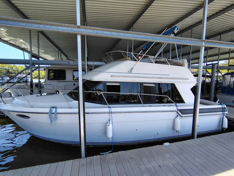 Slide: The Image of 1992 Carver Command Bridge 28 docked under covered marina. - 6