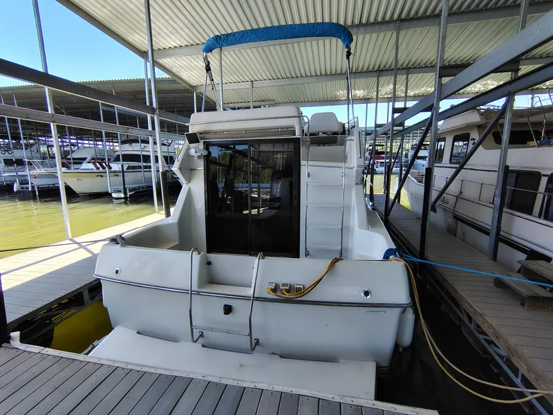 Slide: The Image of 1992 Carver Command Bridge 28 docked in a marina, rear view. - 8