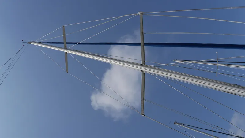 Slide: The Image of Mast of 1986 Ericson 35 MKIII sailboat against blue sky with clouds. - 10