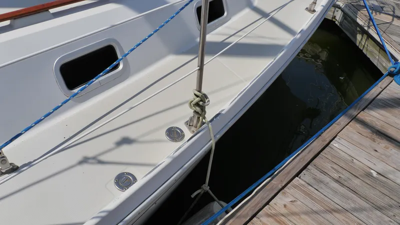 Slide: The Image of 1986 Ericson 35 MKIII sailboat docked, showing deck details and mooring lines. - 11