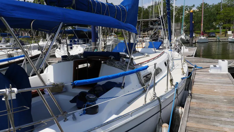 Slide: The Image of 1986 Ericson 35 MKIII sailboat docked at marina with blue covers and rigging. - 12