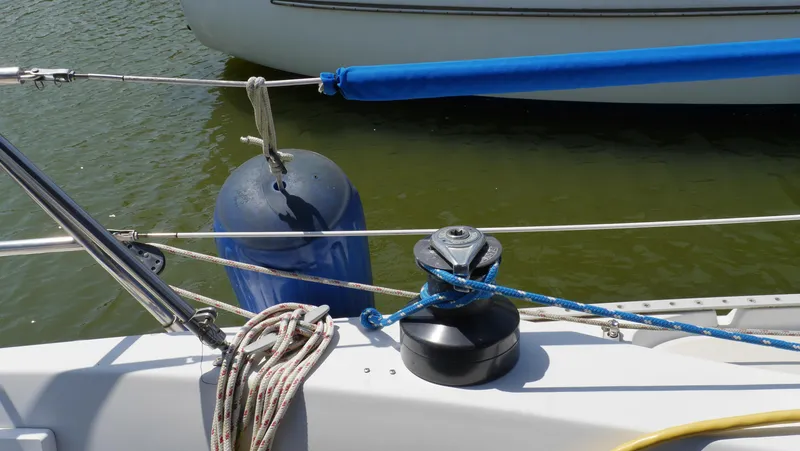 Slide: The Image of Sailboat deck with winch, ropes, and fender on 1986 Ericson 35 MKIII. - 13
