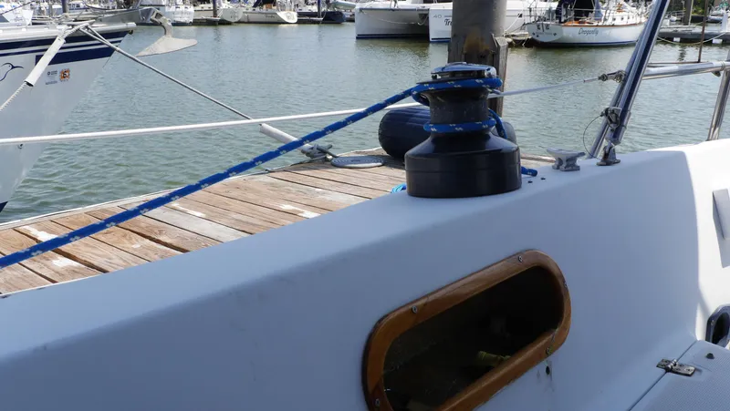 Slide: The Image of 1986 Ericson 35 MKIII sailboat deck with winch and blue rope at marina. - 14