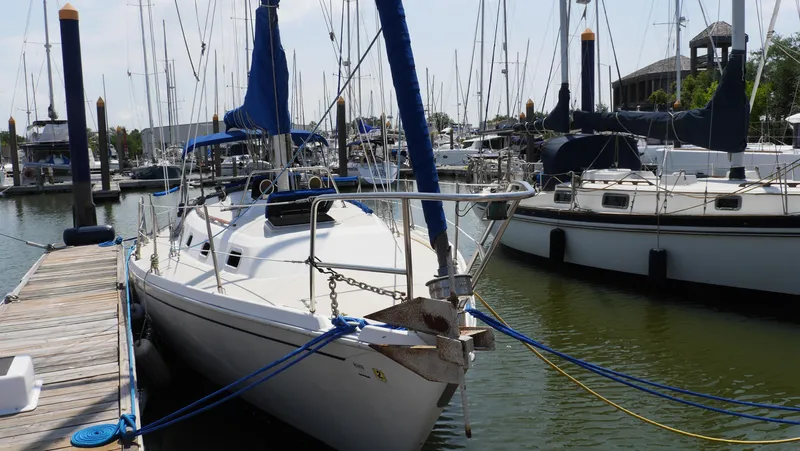 Slide: The Image of 1986 Ericson 35 MKIII sailboat docked in a marina, surrounded by other boats. - 2