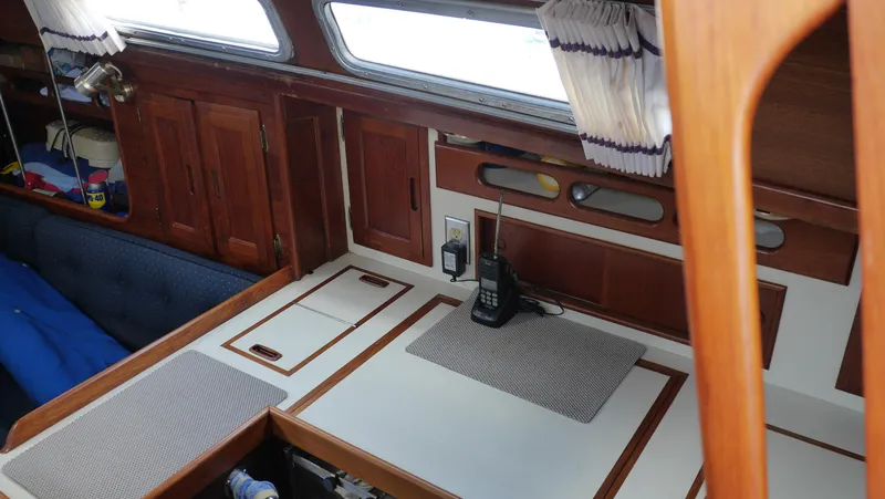 Slide: The Image of 1986 Ericson 35 MKIII yacht interior with wooden cabinetry and navigation equipment. - 20
