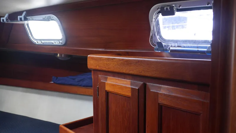 Slide: The Image of Interior of 1986 Ericson 35 MKIII sailboat with wooden cabinetry and portholes. - 27