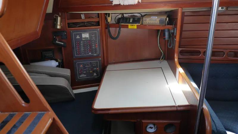 Slide: The Image of Interior of 1986 Ericson 35 MKIII sailboat with navigation station and wooden cabinetry. - 29