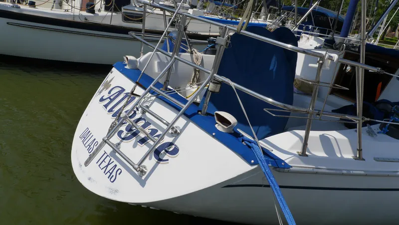 Slide: The Image of 1986 Ericson 35 MKIII sailboat docked, featuring "Allegre" and "Dallas, Texas" on the stern. - 3