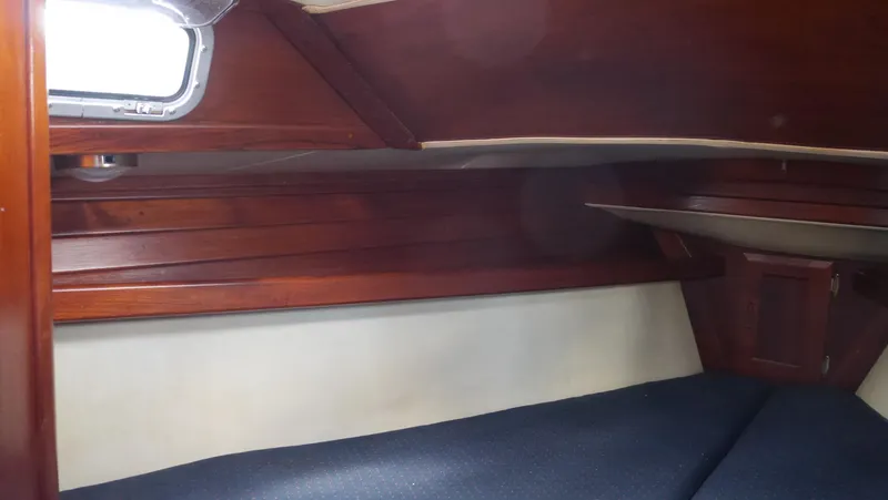 Slide: The Image of Interior cabin of 1986 Ericson 35 MKIII sailboat with wooden paneling and blue upholstery. - 31