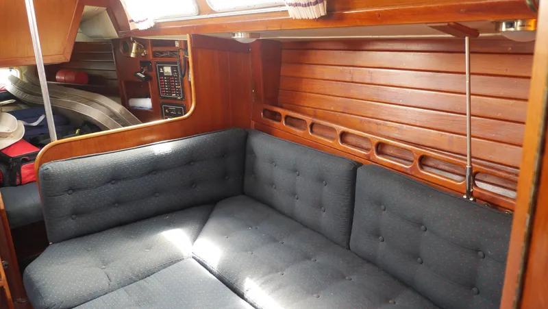 Slide: The Image of Interior of 1986 Ericson 35 MKIII sailboat with wooden paneling and cushioned seating. - 32