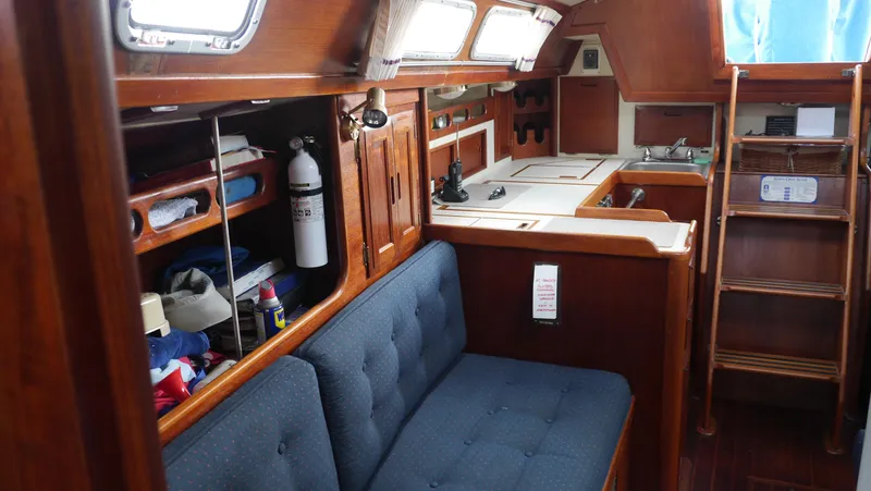 Slide: The Image of Interior of 1986 Ericson 35 MKIII sailboat with wooden cabinetry and blue seating. - 33