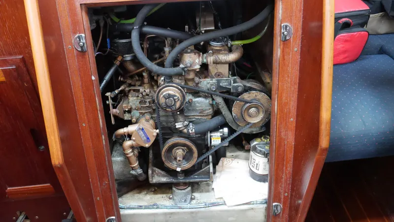 Slide: The Image of 1986 Ericson 35 MKIII engine compartment with visible mechanical components and wooden paneling. - 38