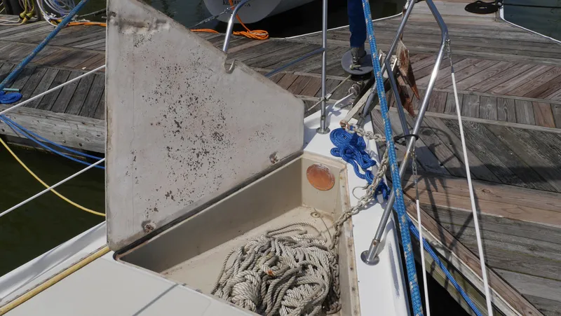 Slide: The Image of Open storage compartment on 1986 Ericson 35 MKIII sailboat with coiled ropes. - 7