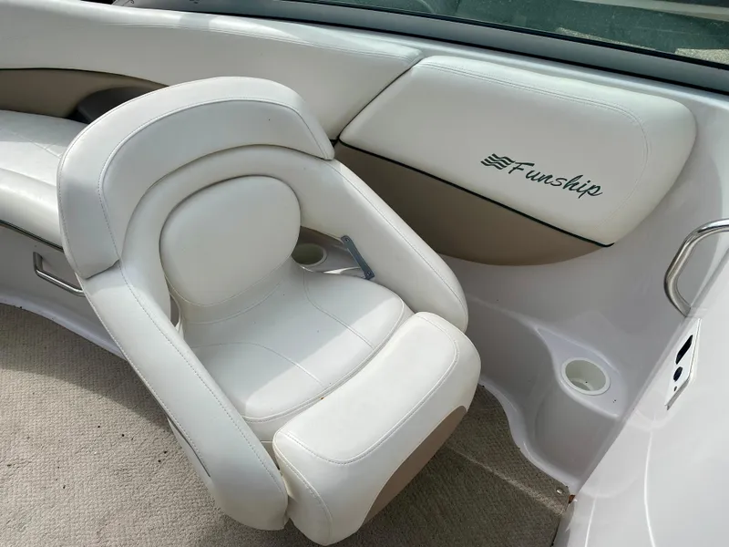 Slide: The Image of 2005 Four Winns 234 Funship boat interior with white seating and "Funship" logo. - 10