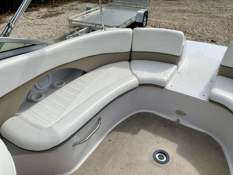 Slide: The Image of 2005 Four Winns 234 Funship boat interior with white seating and cup holders. - 12