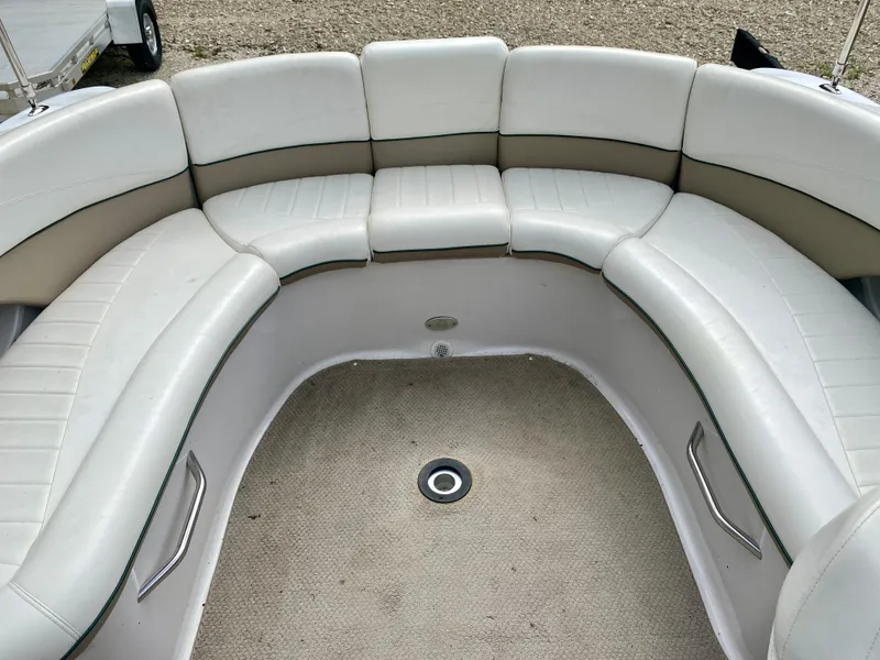 Slide: The Image of 2005 Four Winns 234 Funship boat interior with curved seating and beige upholstery. - 14