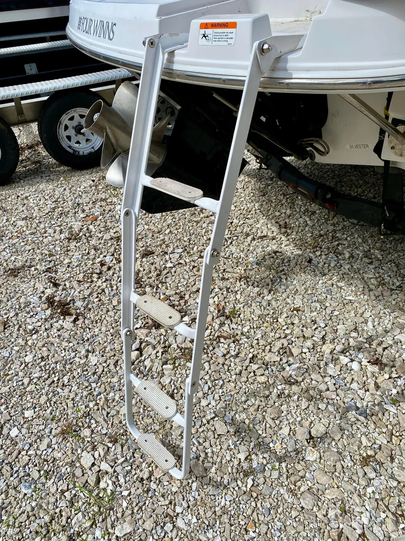 Slide: The Image of Boat ladder on 2005 Four Winns 234 Funship, extended on gravel surface. - 15