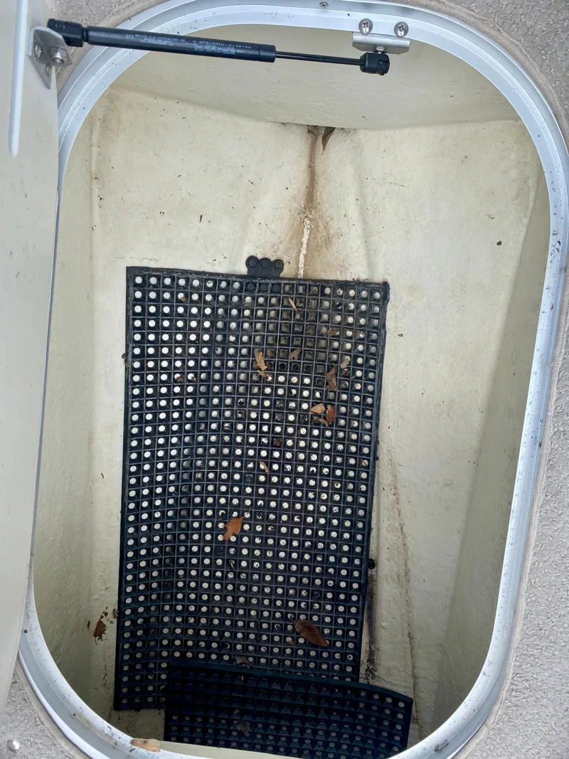 Slide: The Image of Storage compartment of 2005 Four Winns 234 Funship with rubber mat and leaves. - 18