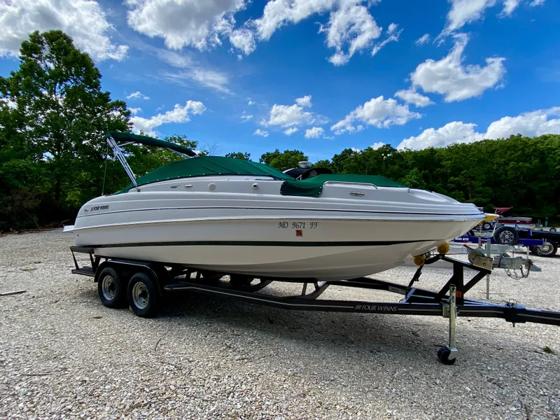 Slide: The Image of 2005 Four Winns 234 Funship boat on trailer under blue sky. - 2