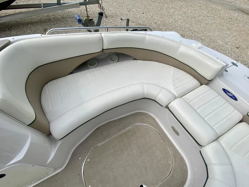 Slide: The Image of 2005 Four Winns 234 Funship boat interior with white and beige seating. - 4