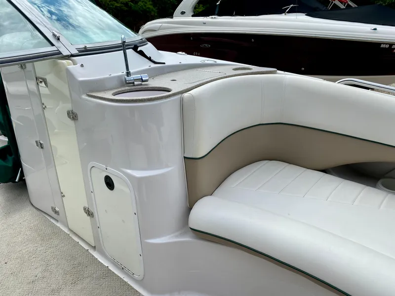 Slide: The Image of 2005 Four Winns 234 Funship boat interior with white seating and cup holders. - 5