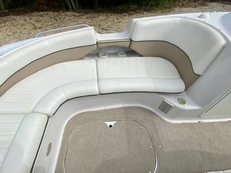 Slide: The Image of 2005 Four Winns 234 Funship boat interior with white seating and beige accents. - 6