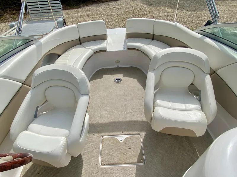 Slide: The Image of 2005 Four Winns 234 Funship boat interior with white seating and carpeted floor. - 7