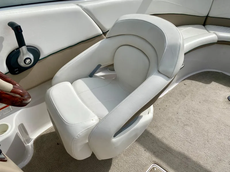 Slide: The Image of 2005 Four Winns 234 Funship boat interior with white captain's chair and beige upholstery. - 8
